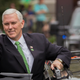 Vice President Mike Pence give a crowd a thumbs-up right before climbing into his motorcade at the Savannah St. Patrick’s Day parade.